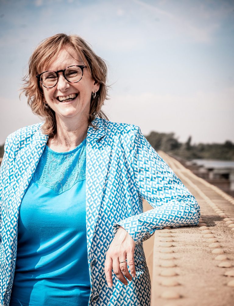 Celest van der Geld lachend in de camera kijkend